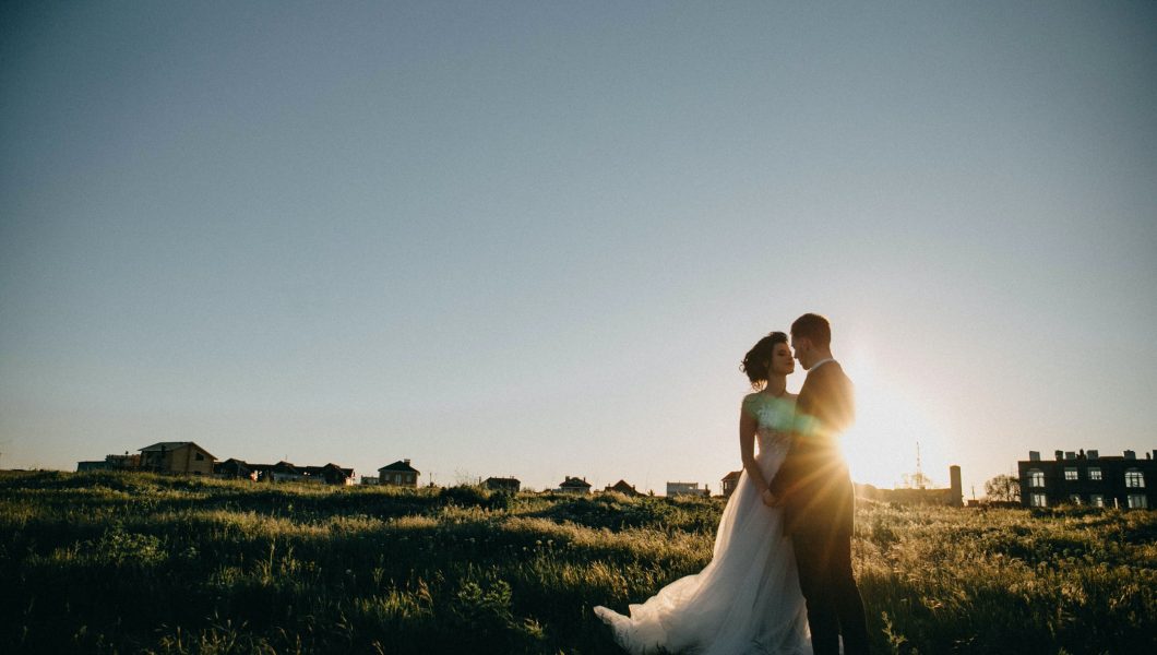 bride and groom on green grass field